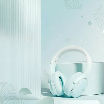 White wireless music headphones with packaging featuring the brand 'Queen' on a light blue background.